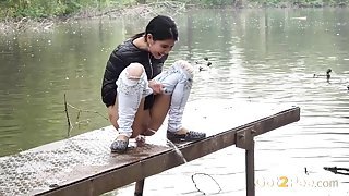 Public pissing girl in jeans goes in two places