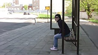 Brunette skank pees in her jeans at a busstop and enjoys herself