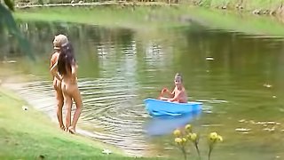 Playful sexy people are enjoying in the nature completely naked surrounded by ducks