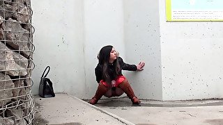 Brunette European chick makes a puddle of pee on the corner