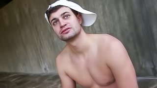 Gay in cap giving massive dick blowjob in close up