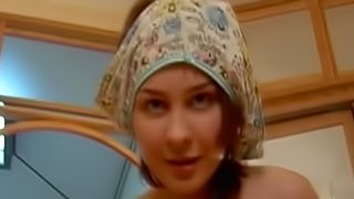 Teen in warm fuzzy cap plays with vagina