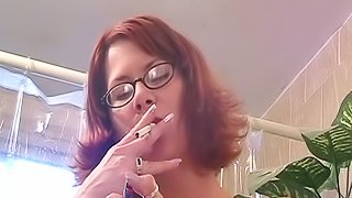 Redhead milf is filmed having a smoke butt naked