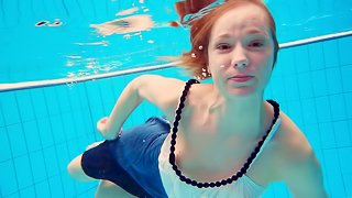 Skinny Russian bint dives into the pool completely naked