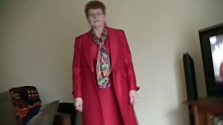 White granny in red coat masturbates on home video