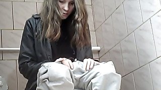 Beautiful tall brunette chick in white jeans pisses in the toilet