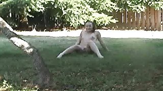 White brunette kinky bitch shows her small boobs at the backyard