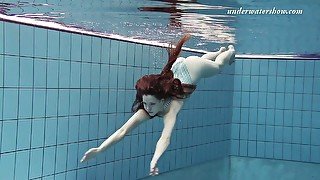 Slim girl Salaka Ribkina swimming in the pool all naked