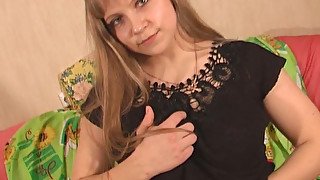 Busty and young Russian girl on the sofa shows her pussy