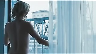 Blonde lady opens up window and seen by passing people while naked.