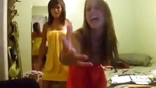 Two frisky student chics enjoys dancing to music