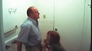 Redhead secretary sucking boss's dick in a toilet