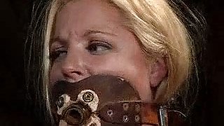 Gagged blonde gets her cute pussy whipped in BDSM scene