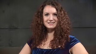Curly-haired brunette has to suck the big dicks of her angry captors