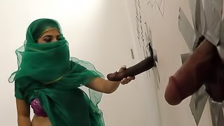 Muslim bitch sucking cocks at a gloryhole and receives a facial