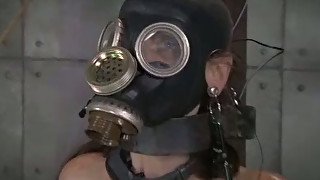 Wanton mommy in gas mask sits in torture chair and waits for punishment