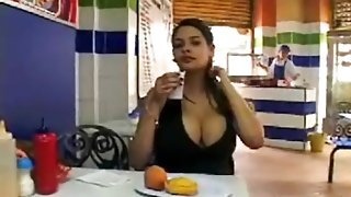 Latina with big tits eats a meal out