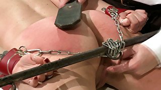 Doctor spanks his patient's ass with a leather paddle in rough BDSM way