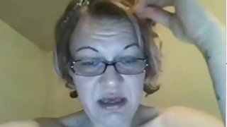 Aged lady in glasses pleases herself with fingers and a dildo