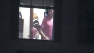 Fem is voyeured flashing her nude titties in window