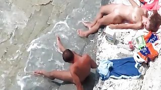 Tanning babe on the beach gets eaten out