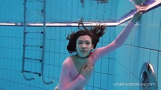 Leggy girl goes swimming in her leotard