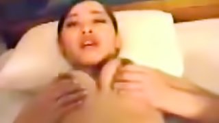 Asian fondles tits during sex