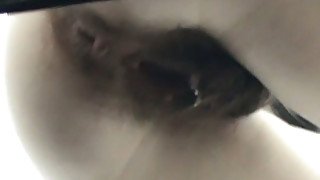 Slender chick with extremely hairy dirty pussy pisses in the toilet