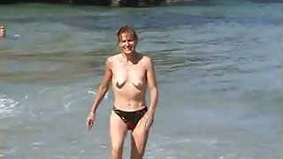 Kinky ugly skinny bitch exposes her small tits outdoors on the beach