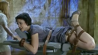 Tied up brunette gets her ass toyed by another girl