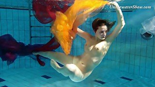 Breath taking underwater show featuring sexy babe in dress