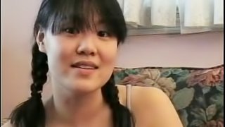 Lovable Asian babe with pigtails getting drilled doggy style