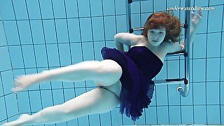 Redhead pale skin Russian college girl undresses underwater