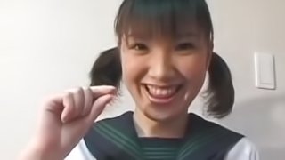 Pigtailed Japanese chick plays with her puss