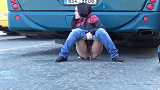 Dirty-minded brunette pulls down jeans to pee at the bus depot