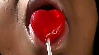 Ebony hussy sucks a lollipop outdoors and takes a ride on a BBC