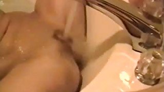 Blonde cutie fucks herself in the hot tub. Homemade video