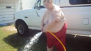 BBW granny with saggy boobs is playing with hose outdoor