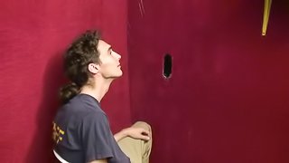 Sexy white gay boy sucks a black cock at the gloryhole