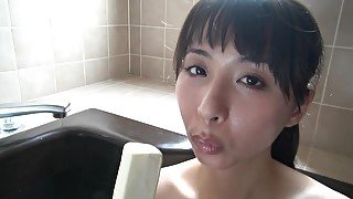 wet young Japanese Asian girl masturbates with icecream in bathtub