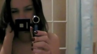 Teen models her naked body and masturbates in mirror