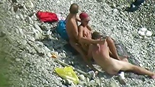 Sexy chick and two horny dudes enjoy foreplay on the beach when I spy them