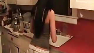 Brunette girl gets fucked doggystyle, while doing the dishes.