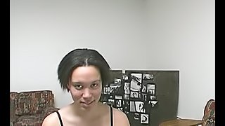 Short-haired brunette girl sucks a dick lying on a bed