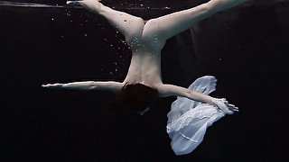 Sweet and special sexy redhead babe in white dress under water