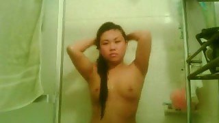 Slutty Asian brunette on webcam masturbating with a dildo