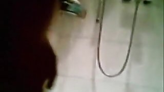 Brunette girl with hairy pussy tapes herself showering