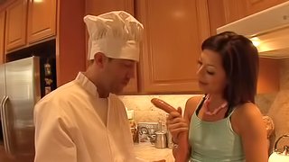 Brunette pornstar awarding her horny guy with blowjob in the kitchen