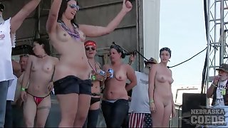 Roadies pour water on topless dancing girls