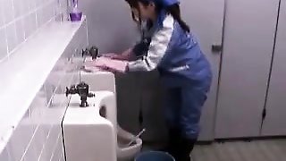 She's cleaning urinals in a public bathroom and gets a cock